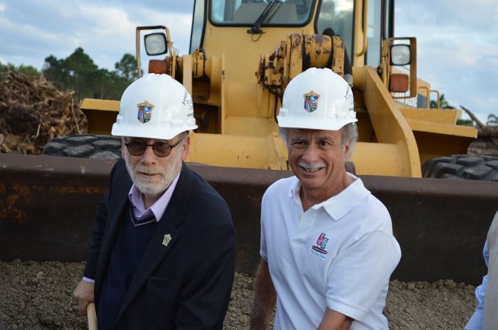 Eric Jablin and Joe Russo wearing hard hats and smiling